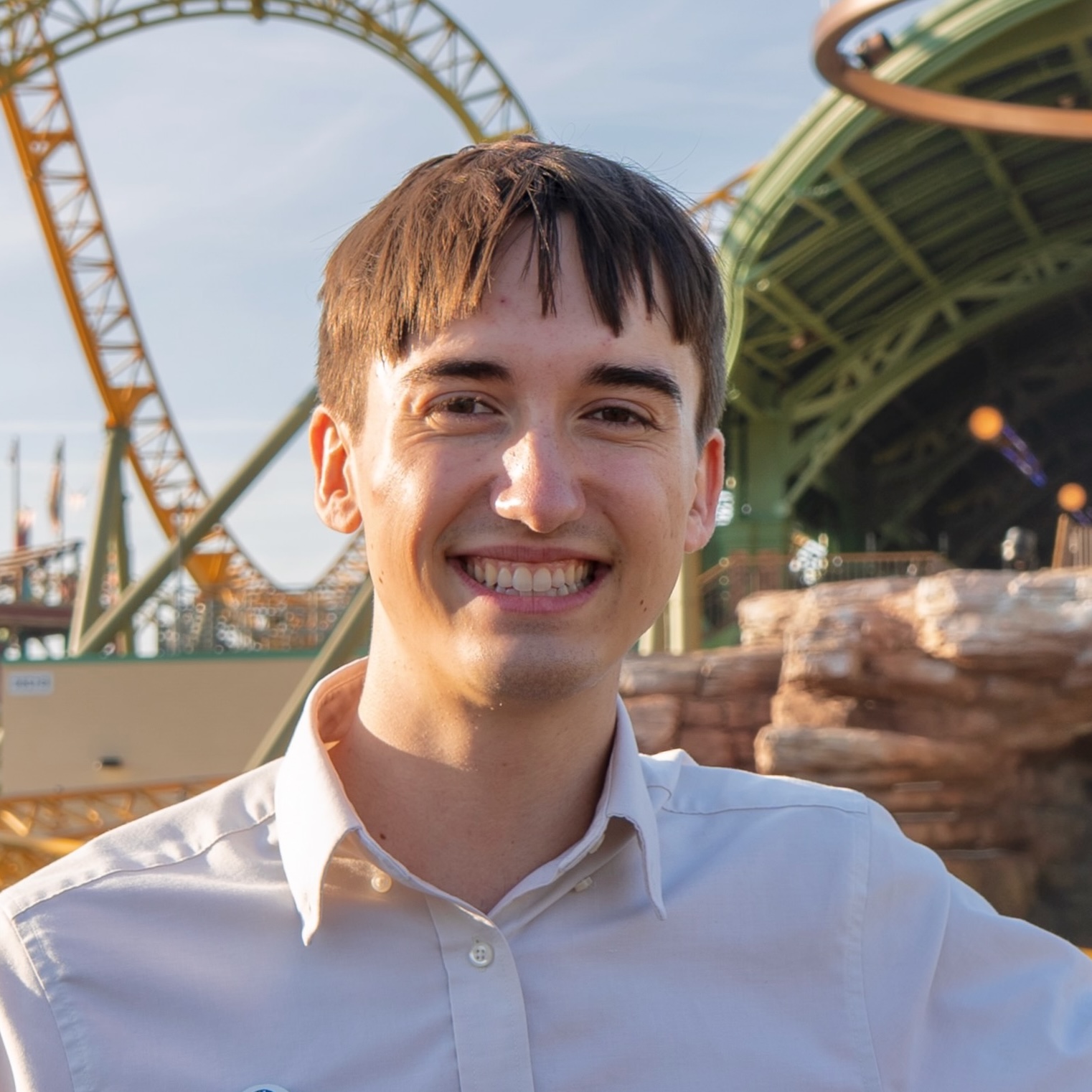 Jeremy Pogue holding a soldering iron in front of an interactive mini-golf course.
